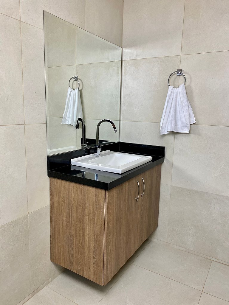 Quarto casal confortável com TV e frigobar